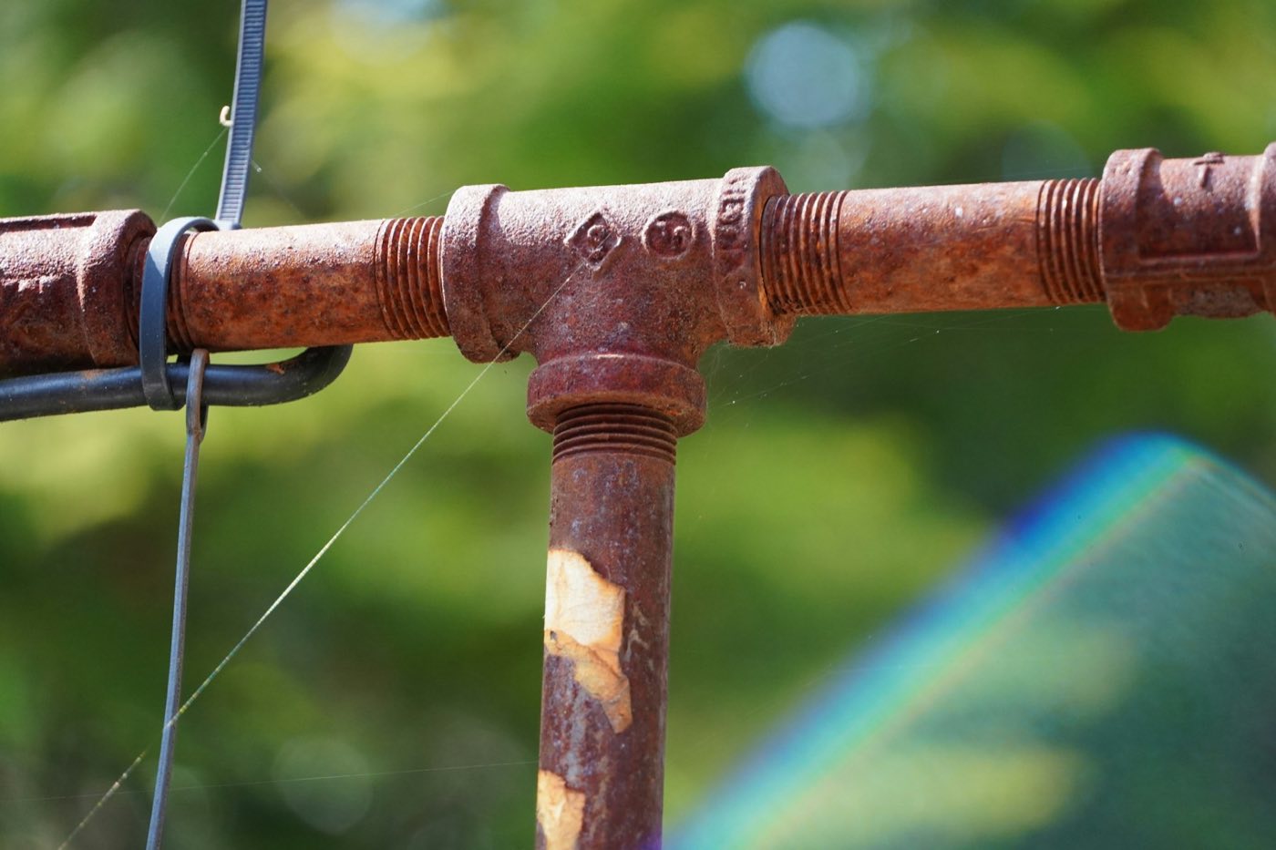 Close-up of a rusted pipe T-fitting